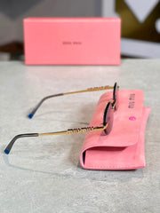 Gafas Miu Miu ovalada dorada humo
