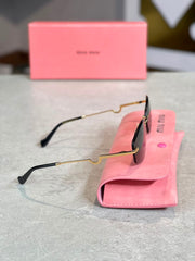 Gafas Miu Miu ovalada dorada humo