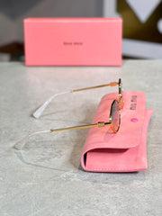 Gafas Miu Miu ovalada dorada humo